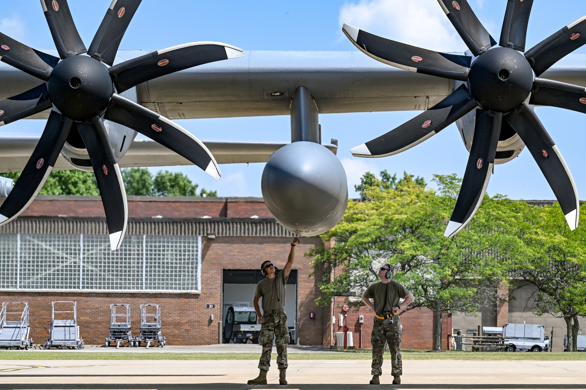 Crew chiefs with the 94th Airlift Wing prepare for takeoff under the wing of a C-130H Hercules loaded with civic leaders from Dobbins Air Reserve Base, Georgia, on Aug. 14, 2025, at Youngstown Air Reserve Station, Ohio.