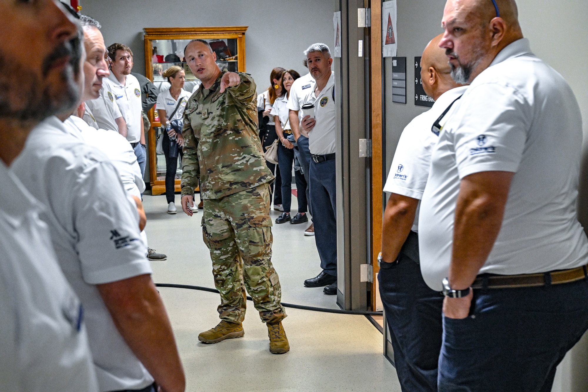 Tech. Sgt. Brandon Wilkins, a Defender with the 910th Security Forces Squadron, gives a tour of a SF training facility to civic leaders from Dobbins Air Reserve Base, Georgia, on Aug. 14, 2025, at Youngstown Air Reserve Station, Ohio.