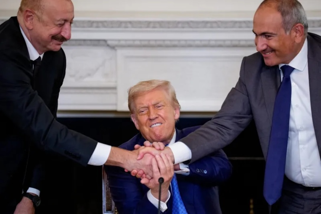 Azerbaijani President Ilham Aliyev, U.S. President Donald Trump, and Armenian Prime Minister Nikol Pashinyan join hands during a signing ceremony at the White House in Washington.