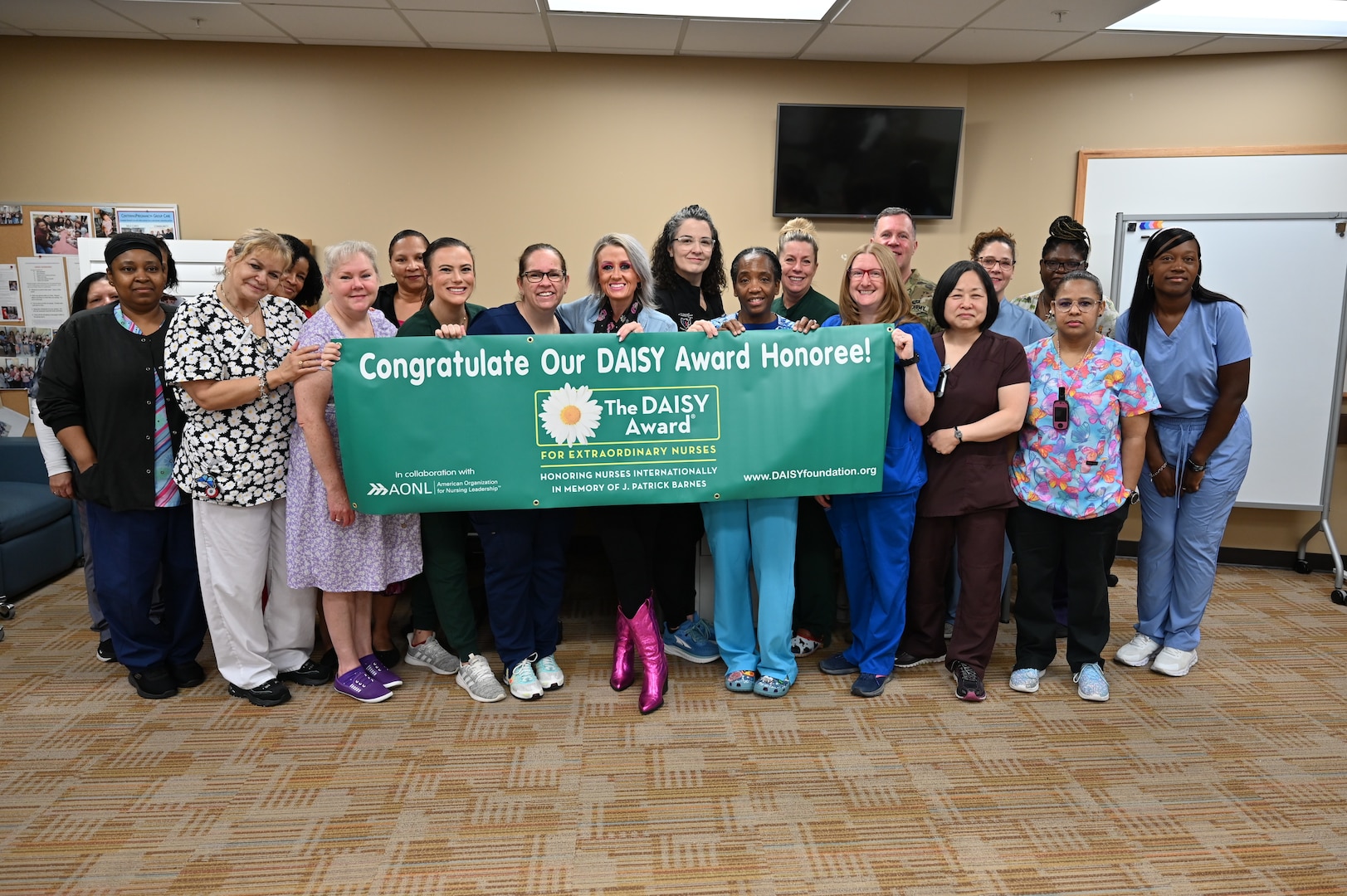 Registered Nurse Susan Clapp poses for a photo with her team after receiving the CRDAMC Outpatient DAISY award.