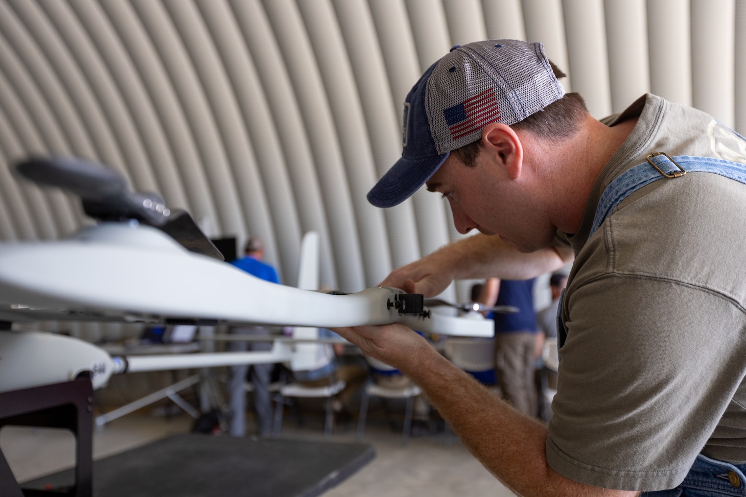 Gavin Abel, Lockheed Martin, assembles a Stalker unmanned aircraft system (UAS) during a technical demonstration held at Outlying Landing Field Seagle in Twentynine Palms, Calif. May 19-21, 2025. The U.S. Naval Research Laboratory in conjunction with the Operational Energy Capability Improvement Fund with the Office of the Assistant Secretary of Defense for Energy, Installations, and Environment, and the Marine Corps Expeditionary Energy Office (E2O) conducted the demonstration aiming to develop a technology for Navy vessels to "see over the horizon" using a combination of stratospheric high-altitude balloons (HABs) and unmanned aircraft.  (U.S. Marine Corps photo by Pfc. Jozef Mejewski/Released)