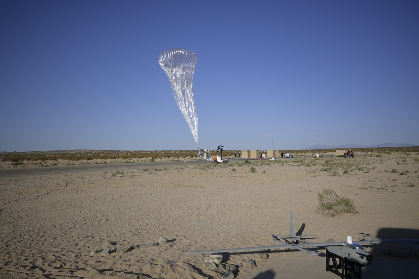 An Aerostar High Altitude Balloon (HAB) launches during a technical demonstration held at Outlying Landing Field Seagle in Twentynine Palms, Calif. May 19-21, 2025. The U.S. Naval Research Laboratory in conjunction with the Operational Energy Capability Improvement Fund with the Office of the Assistant Secretary of Defense for Energy, Installations, and the Marine Corps Expeditionary Energy Office (E2O) conducted the demonstration aiming to develop a technology for Navy vessels to "see over the horizon" using a combination of stratospheric high-altitude balloons (HABs) and unmanned aircraft.  (Photo by Christopher Fischelli)