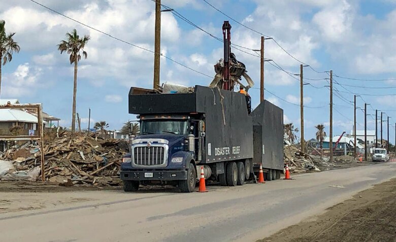 Dump truck picking up debris from Hurricane Maria.