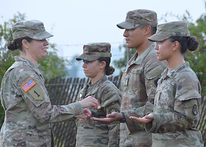 Lieutenants of Signal Basic Officer Leader Course (SBOLC) Class 005-25 reached a major milestone in their careers last week! The Signaleers were honored in a pinning ceremony after completing an early morning ruck march that culminated at the 442nd Signal Battalion Motor Pool. 
Maj. Gen. Christopher L. Eubank, Chief of Staff, U.S. Strategic Command, and Col. Julia M. Donley, U.S. Army Signal School Commandant and 43rd Chief of Signal, welcomed the lieutenants upon their completion of the ruck and participated in the pinning ceremony.
The design of the Signal regimental insignia originated from a meeting of Signal Corps officers led by Maj. Alfred J. Myer, the Chief Signal Officer, in 1865. A gold eagle holds in its talons a golden baton from which descends a signal flag. The motto “Pro Patria Vigilans” – meaning “Watchful for the Country” – reflects the Signal Corps’ mission to provide and maintain vital communications. 
SBOLC Class 005-25 will graduate from the 16-week course on Thursday then prepare to report to their respective duty stations.