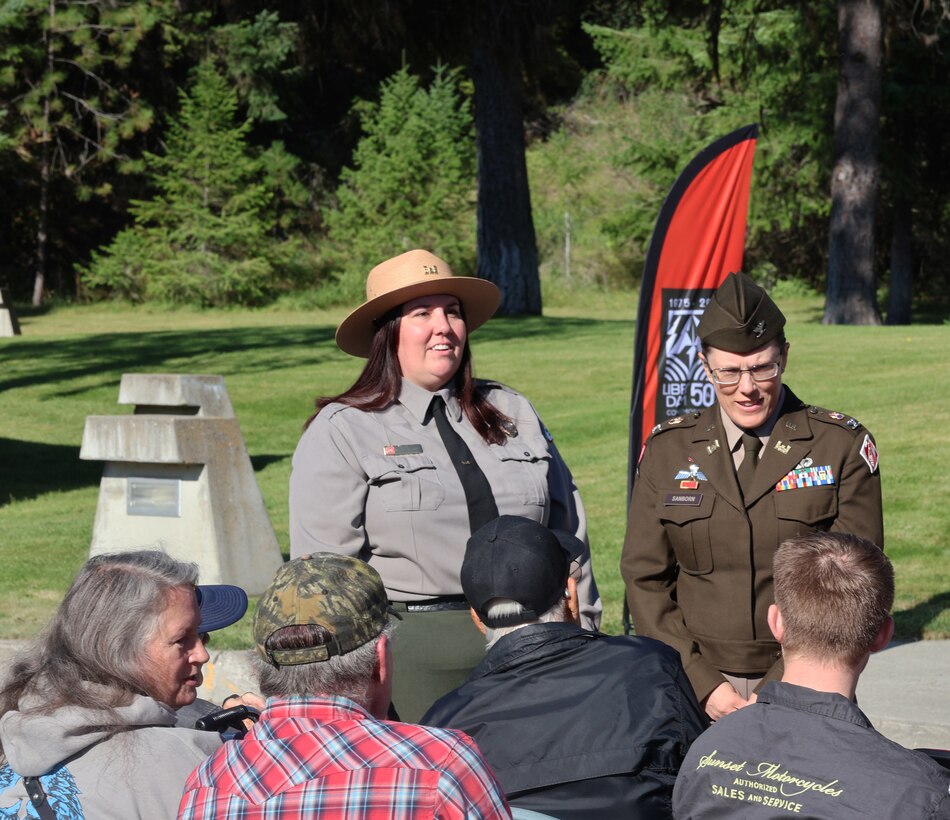 U.S. Army Corps of Engineers, Seattle District Commander Col. Kathryn Sanborn and Libby Dam Natural Resource Manager Tana Wilson chat with members of the public who attended the 50th commemoration of the dedication of the dam, Aug. 23, 2025. The colonel spoke with family members of the 12 men who lost their lives during the dam's construction, between 1966 and 1972. Their names were listed on a memorial Sanborn and Wilson unveiled during the event.
