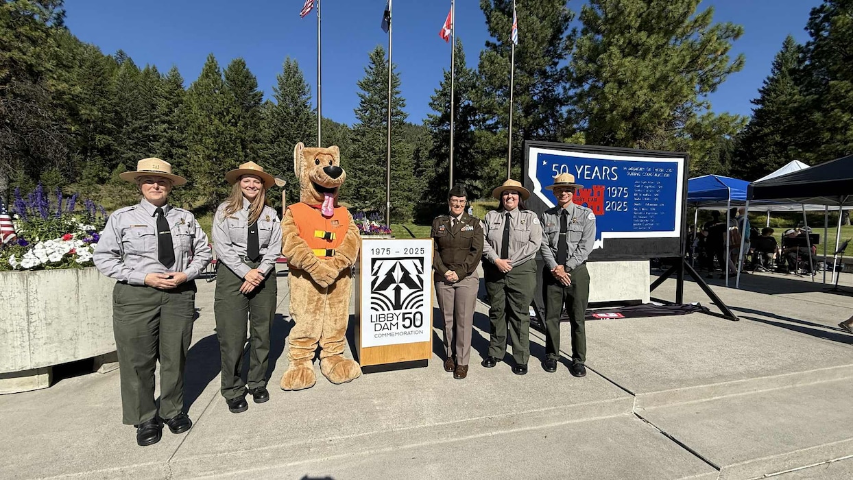 U.S. Army Corps of Engineers, Seattle District Commander Col. Kathryn Sanborn with members of the district's natural resource specialist team and Bobber the Water Safety Dog, pose for a group photo during Libby Dam's 50th commemoration, Aug. 23, 2025, at Libby, Montana.
