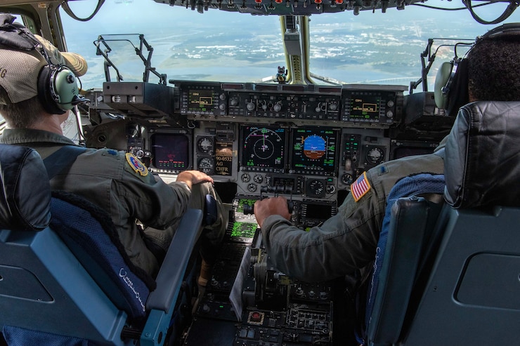 U.S. Air Force Lt. Col. Lindon Rainey, left, and 1st Lt. John Jackson, both pilots with the 156th Airlift Squadron, sits in the cockpit of a C-17 Globemaster III as they prepare to complete a touch and go at the Myrtle Beach International Airport in Myrtle Beach, South Carolina, Oct. 5, 2023.