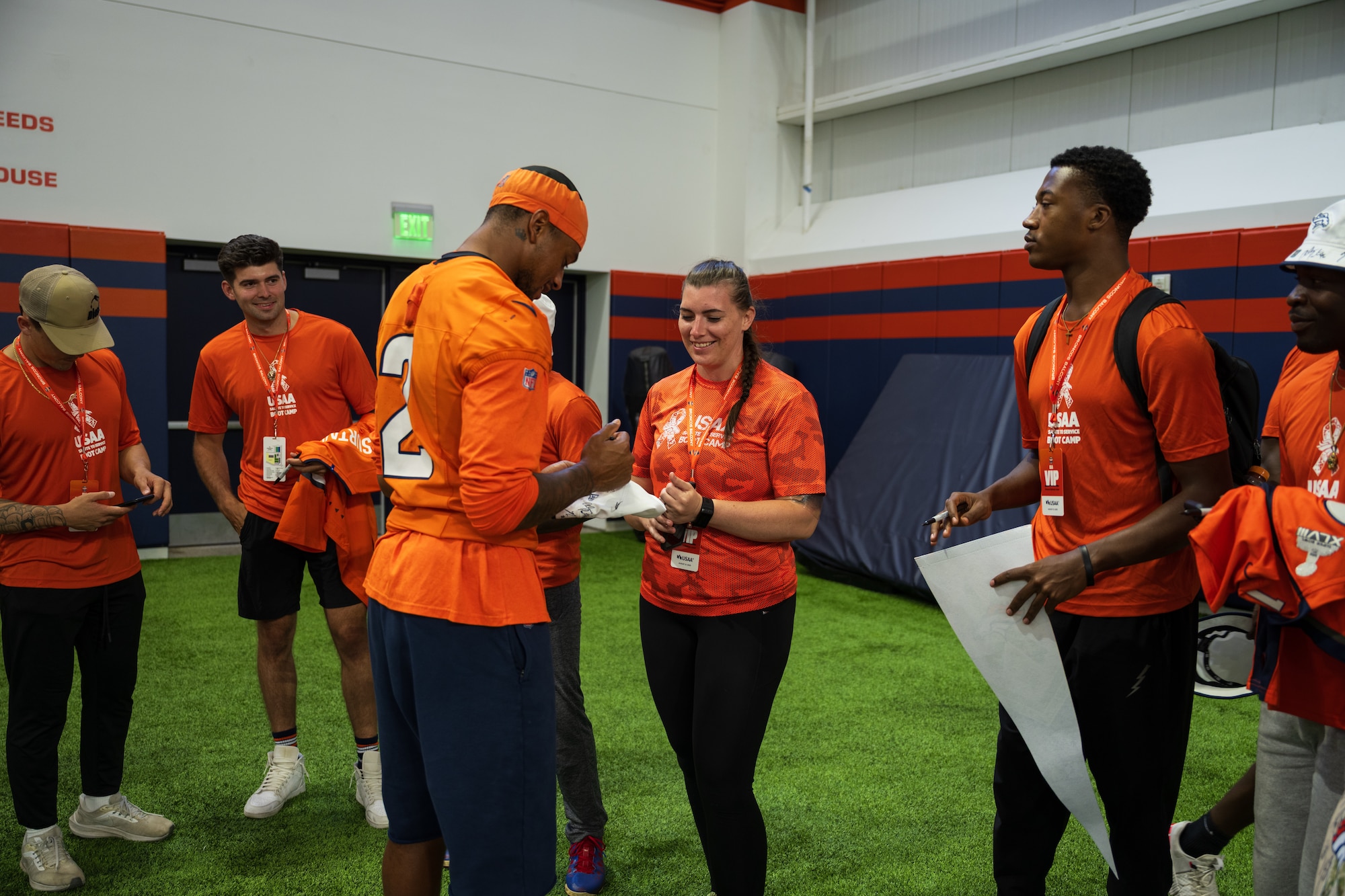 service members getting autographs from Denver Broncos players