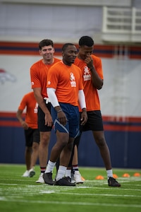 three men standing by one another