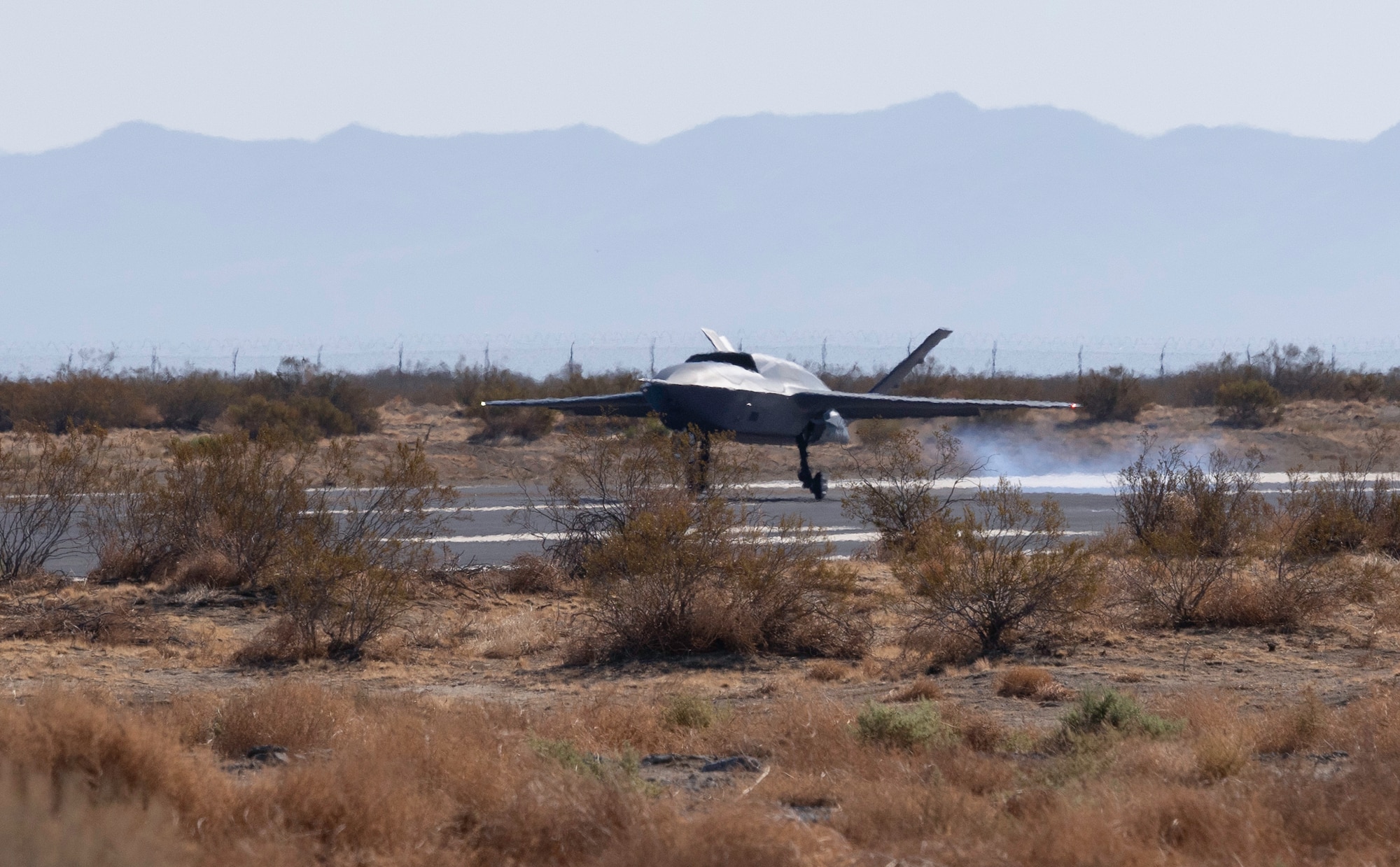An aircraft lands on a runway.