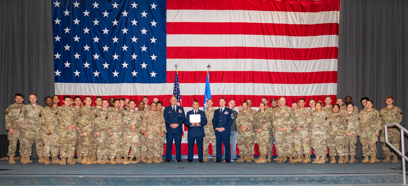 U.S. Air Force Airman 1st Class Tykhon Rudenok, 2nd Civil Engineer Squadron heating, ventilation and air conditioning journeyman, poses for a photo with his leadership and fellow Airmen during a Naturalization Ceremony at Barksdale Air Force Base, Louisiana, July 15, 2025. Rudenok is currently serving in the Air Force to give back to the country that gave him opportunities when he immigrated to the U.S. (U.S. Air Force photo by Airman 1st Class Jaiyah Lewis)