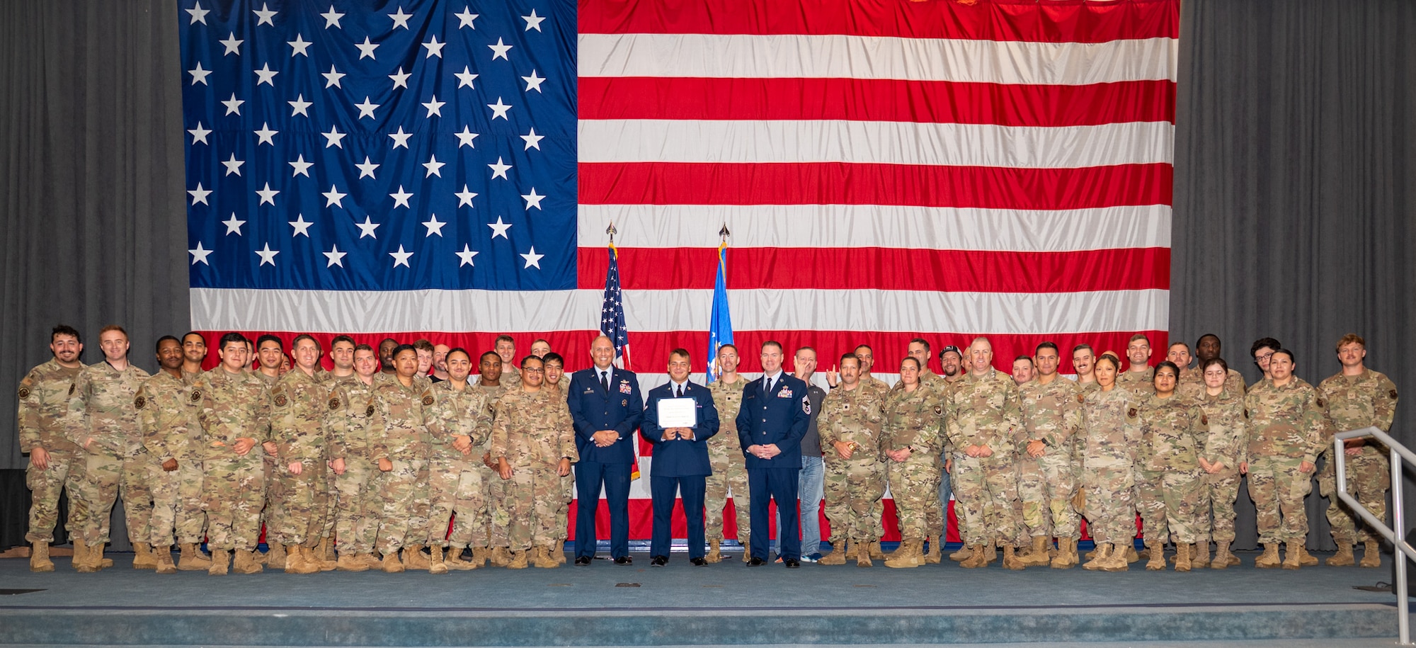 U.S. Air Force Airman 1st Class Tykhon Rudenok, 2nd Civil Engineer Squadron heating, ventilation and air conditioning journeyman, poses for a photo with his leadership and fellow Airmen during a Naturalization Ceremony at Barksdale Air Force Base, Louisiana, July 15, 2025. Rudenok is currently serving in the Air Force to give back to the country that gave him opportunities when he immigrated to the U.S. (U.S. Air Force photo by Airman 1st Class Jaiyah Lewis)