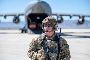 Man stands with plane behind him.