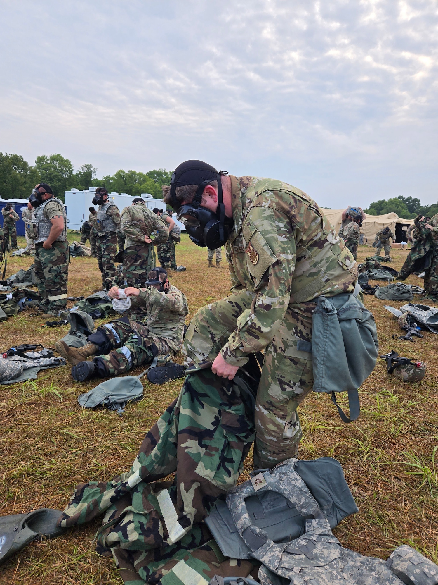 U.S. Air National Guard Airmen don mission-oriented protective posture gear during Exercise Northern Strike 25-2 at Fort Custer, Michigan, Aug. 8, 2025. Northern Strike is a National Guard led exercise building mission ready Airmen by enhancing expeditionary operational skills in realistic contested environments. (U.S. Air National Guard photo by Master Sgt. John E. Hillier)