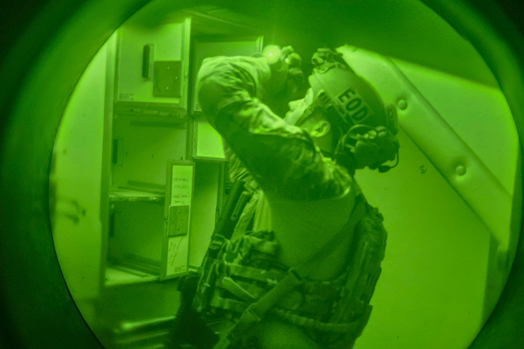 A U.S. Air Force explosive ordnance disposal (EOD) Airman searches a plane cabin during a simulated scenario involving night vision operations training at Exercise Northern Strike 25-2, Aug. 7, 2025, in Oscoda, Michigan. The night vision training was conducted to enhance EOD Airmen’s ability to operate in nighttime and low-light environments, sharpening their skills and ensuring they remain mission ready. (U.S. Air National Guard photo by Staff Sgt. Whitney Erhart)