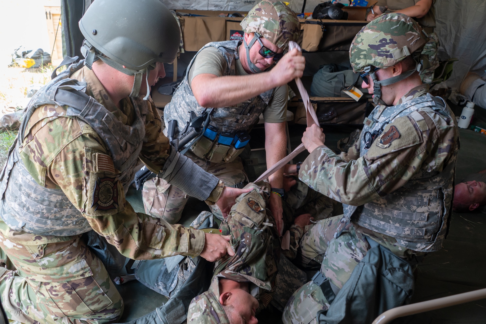 U.S. Airmen practice tactical combat casualty care during Northern Strike 25-2 at Fort Custer, Michigan, Aug. 7, 2025. Northern strike is a National Guard training event for joint operations designed to build readiness with multi-service and partner forces in all domains of warfare. (U.S. Air National Guard photo by Senior Airman Phoenix Lietch)
