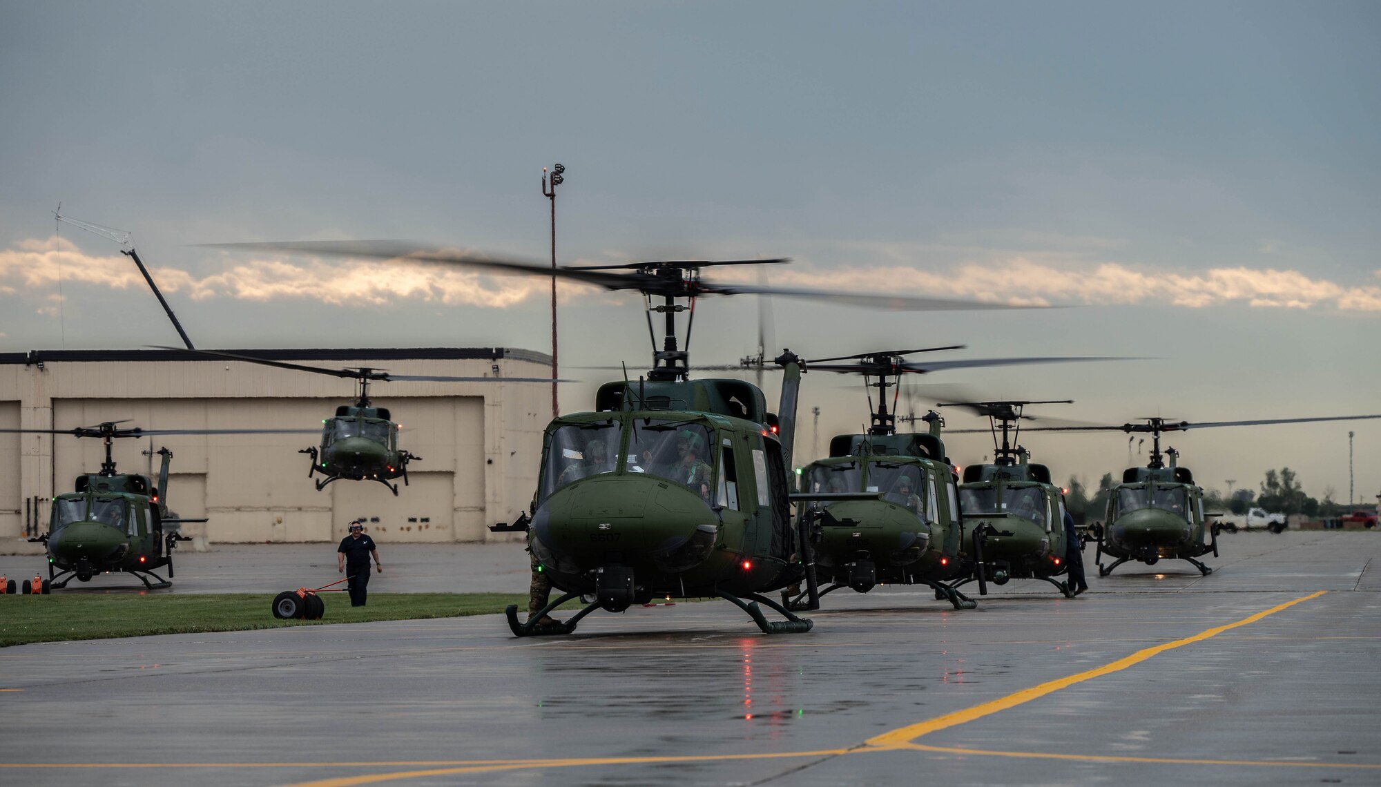 A line of UH-1N Iroquois helicopters prepare for take off for a formation flight during a Tactical Response Force exercise at Minot Air Force Base, North Dakota, Aug. 21, 2025. The UH-1N has been stationed at Minot AFB since March 20, 1980 and is scheduled to remain until 2029, with the MH-139A expected to arrive in 2027. (U.S. Air Force photo by Senior Airman Alyssa Bankston)