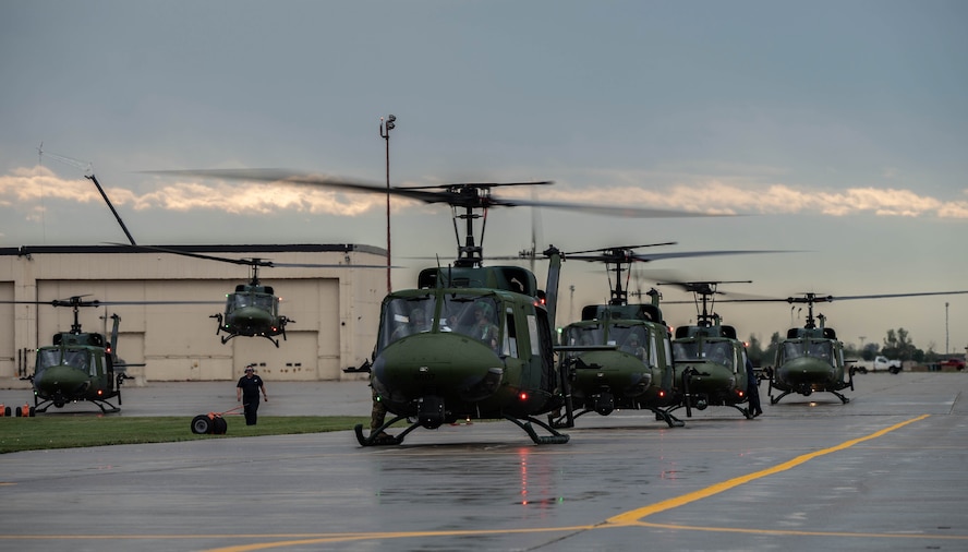 A line of UH-1N Iroquois helicopters prepare for take off for a formation flight during a Tactical Response Force exercise at Minot Air Force Base, North Dakota, Aug. 21, 2025. The UH-1N has been stationed at Minot AFB since March 20, 1980 and is scheduled to remain until 2029, with the MH-139A expected to arrive in 2027. (U.S. Air Force photo by Senior Airman Alyssa Bankston)