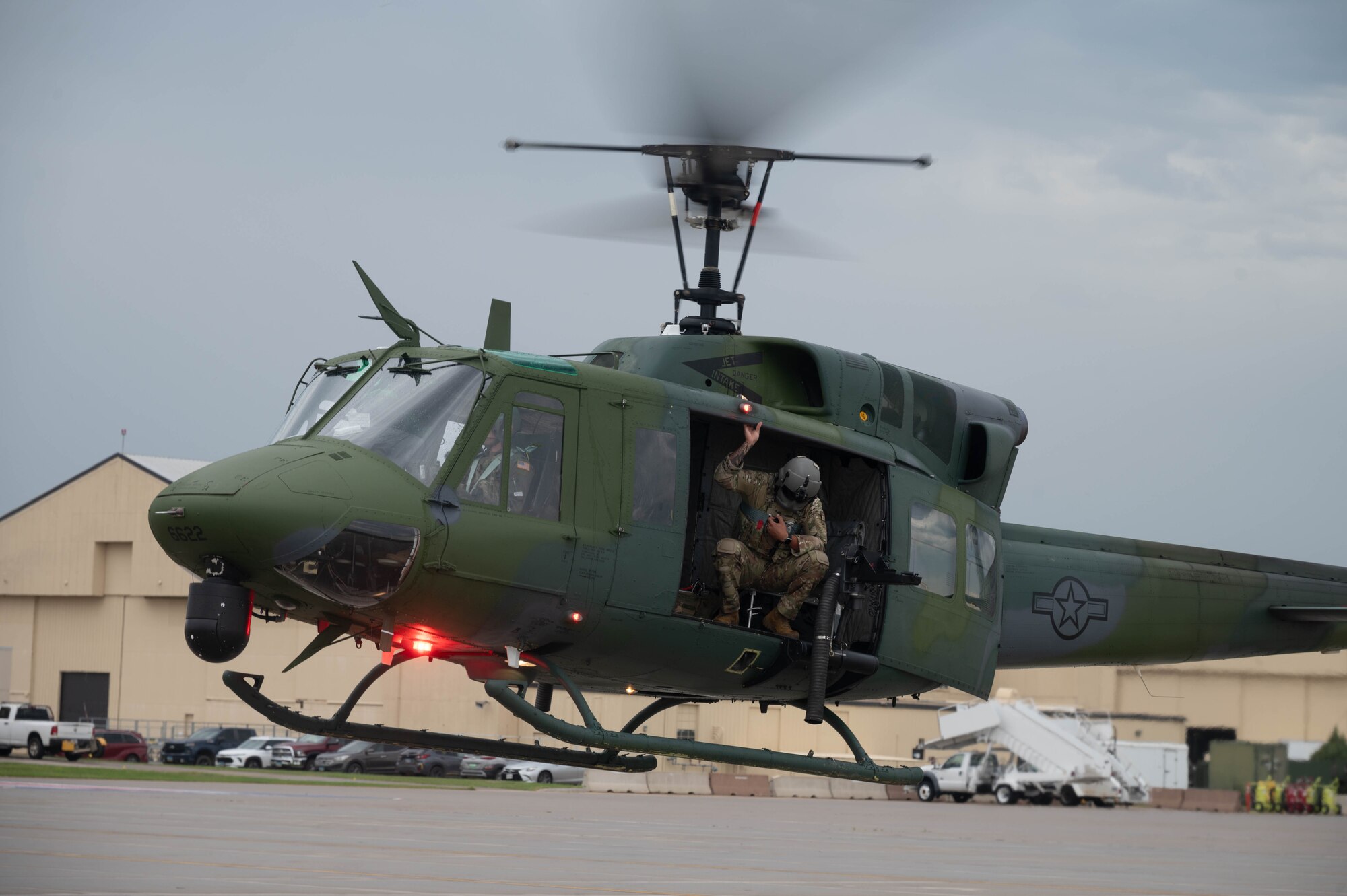 A UH-1N Iroquois helicopter takes off on the flightline for a formation flight at Minot Air Force Base, North Dakota, Aug. 21, 2025. The Air Force began using the UH-1N Iroquois in 1970 for search and rescue missions and later expanded its role to include missile security. (U.S. Air Force photo by Airman 1st Class Wesley Davies)
