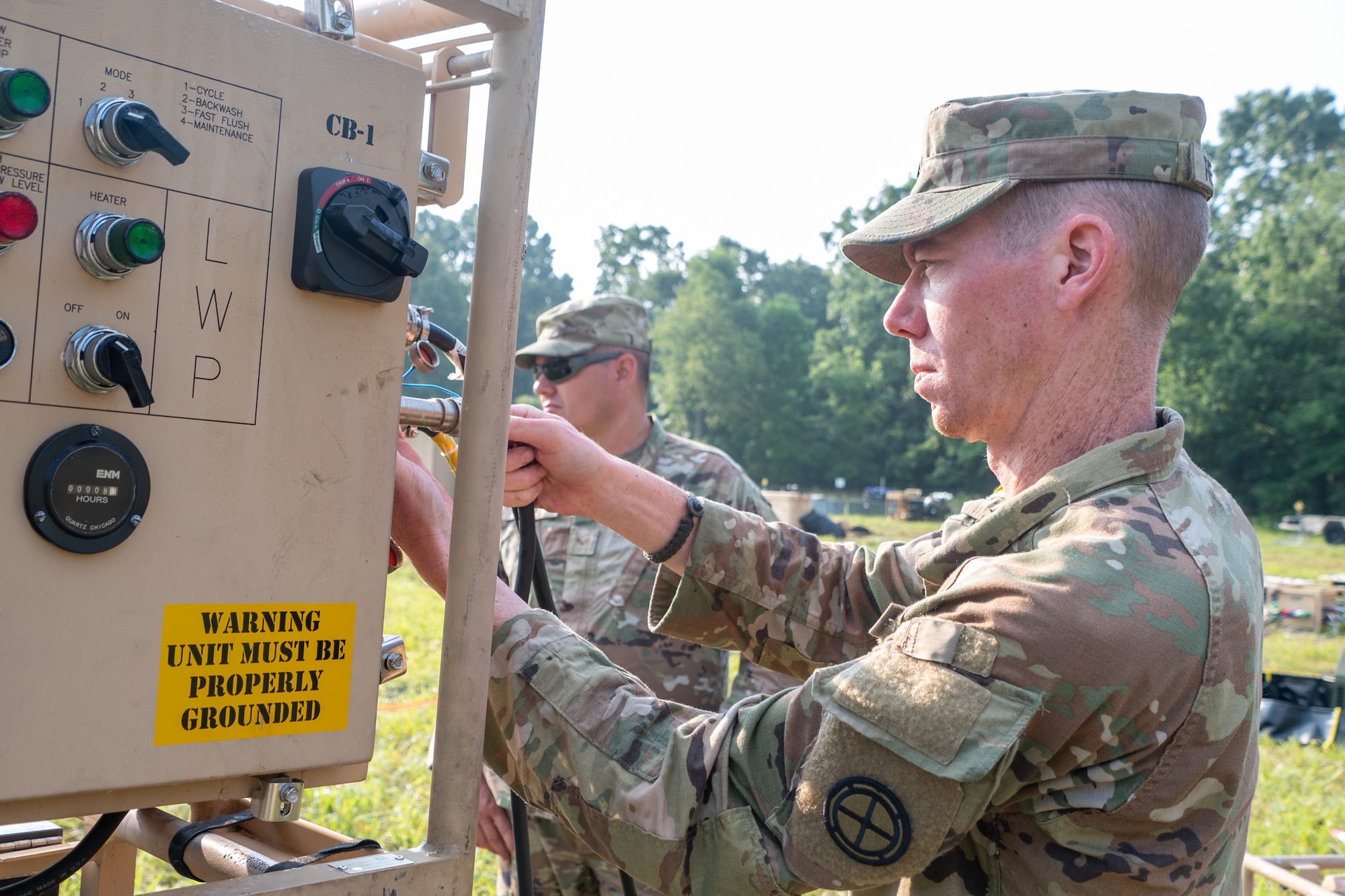 U.S. Army National Guard Sgt. Erin Reagin, water treatment specialist with Alpha Company 935th Aviation Support Battalion inspects a water treatment system during Northern Strike 25-2 at Fort Custer, Michigan, Aug. 5, 2025. Northern Strike is a National Guard led exercise designed to strengthen warfighting capabilities and develop leaders while enhancing joint interoperability. (U.S. Air National Guard photo by Senior Airman Phoenix Lietch)