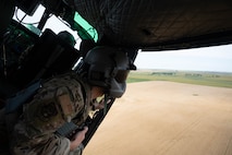 U.S. Air Force Staff Sgt. Garrett Hightower, a 54th Helicopter Squadron special missions aviator, looks out of a UH-1N Iroquois helicopter during a turn at Minot Air Force Base, North Dakota, Aug. 21, 2025. The UH-1N has been stationed at Minot AFB since March 20, 1980 and is scheduled to remain until 2029, with the MH-139A expected to arrive in 2027. (U.S. Air Force photo by Airman 1st Class Wesley Davies)