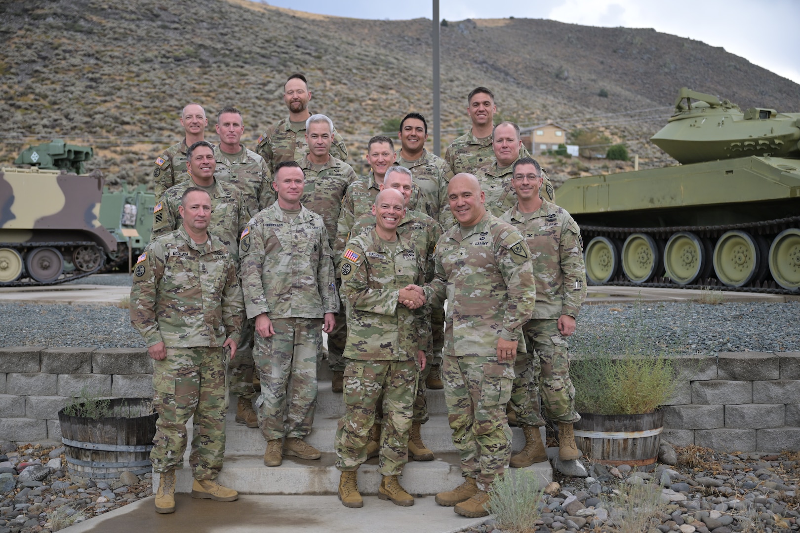 Brig. Gen. Randy Lau, right, Nevada land component commander, and Brig. Gen. James Packwood, right, Idaho assistant adjutant general, Army, shake hands in front of Nevada and Idaho Army Guard leadership during a planning meeting Aug. 27, 2025.