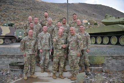 Brig. Gen. Randy Lau, right, Nevada land component commander, and Brig. Gen. James Packwood, right, Idaho assistant adjutant general, Army, shake hands in front of Nevada and Idaho Army Guard leadership during a planning meeting Aug. 27, 2025.