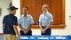 Airman 1st Class Vincent Padilla & Wesley Davies, 5th Bomb Wing public affairs specialists, welcome a member of the Minot community during the Sentinel program town hall in Minot, North Dakota, Aug. 26, 2025. The activity educated residents, civic leaders, and local workforce members regarding major features of the Sentinel program, such as future developments, economic benefits, infrastructure construction, and environmental investigations.