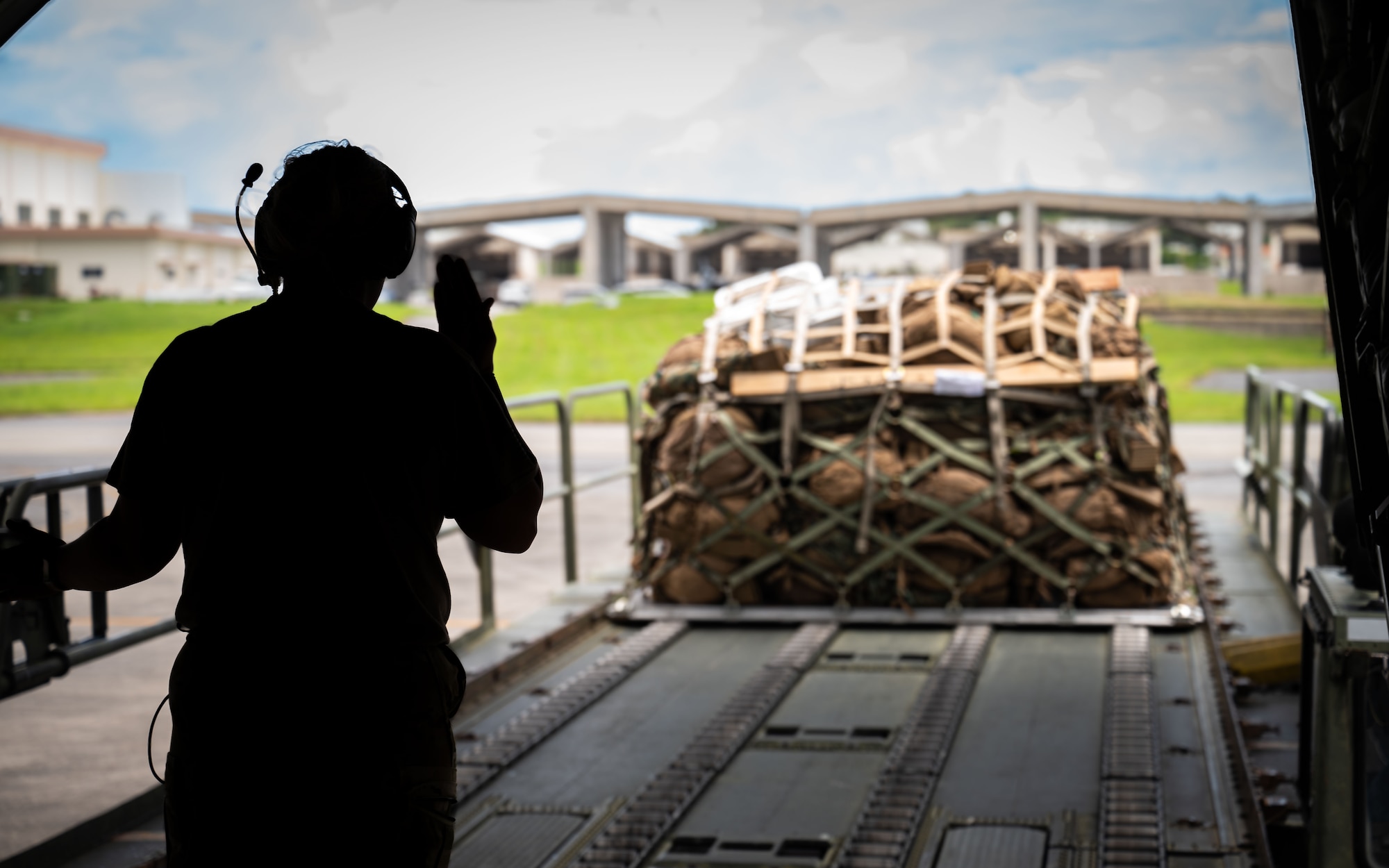 Airman loads cargo on aircraft.
