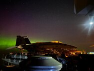 The Aurora Borealis appears in the night sky over the Nimitz-class aircraft carrier USS Abraham Lincoln (CVN 72) as the ship transits the North Pacific Ocean during exercise Northern Edge 2025 (NE25), Aug. 18.