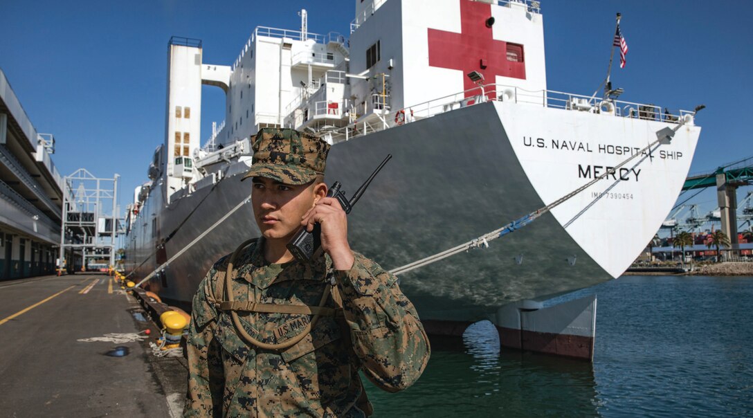 Marine Corps Private First Class Arnoldo RomeroVelazco, rifleman with 1st Battalion, 4th Marine Regiment, 1st Marine Division, posts security to secure Military Sealift Command hospital ship USNS Mercy in Los Angeles, California, March 27, 2020, deployed in support of Nation’s COVID-19
response efforts.