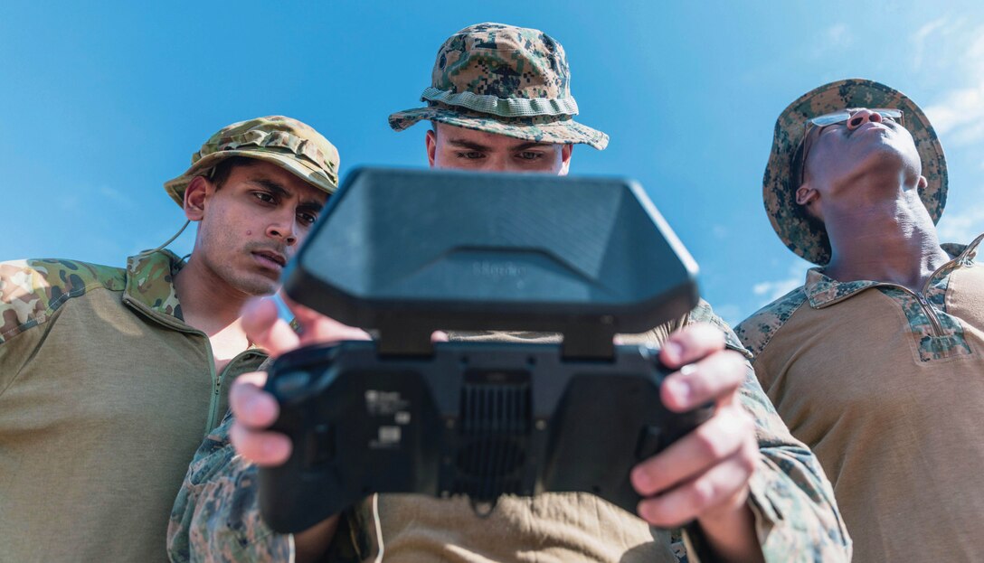Lieutenant Tushar Madan, left, U.S. Navy exchange officer to Australia’s Headquarters Joint Operations Command J2 branch; U.S. Marine Corps
Corporal Brian Vile, center, intelligence specialist; and Corporal Salmon Shaedon, assistant forecaster, both with Marine Rotational Force–
Darwin 24.3, operate Skydio drone as part of counter–unmanned aircraft systems field test at Mount Bundey Training Area, Northern Territory,
Australia.