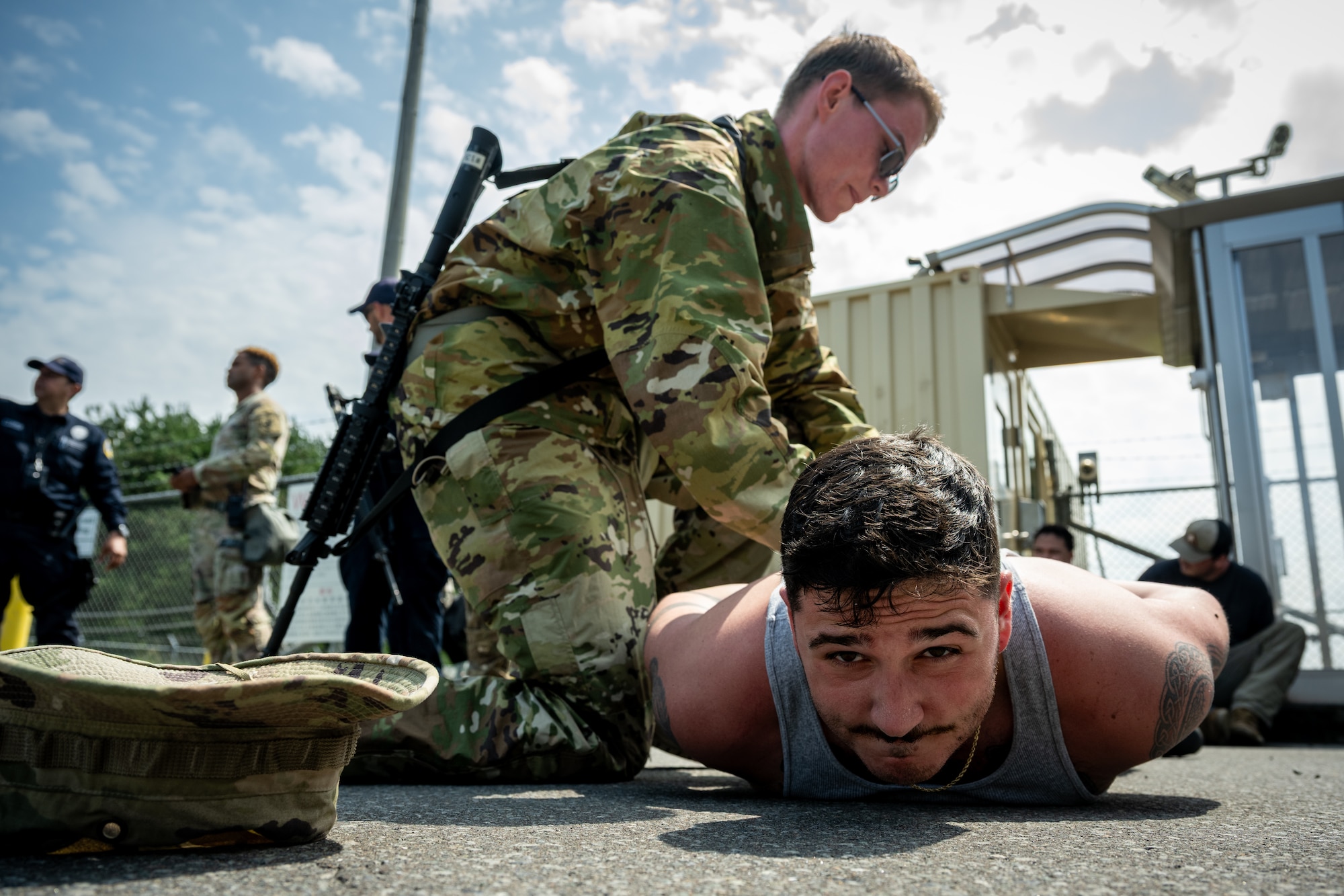 U.S. Army Pfc. Brennan Love, 10th Missile Defense Battery RADAR operator, searches for weapons on a U.S. Air Force Airman assigned to the 35th Security Forces Squadron during a simulated base defense scenario at Shariki Communications Site, Japan, Aug. 19, 2025.