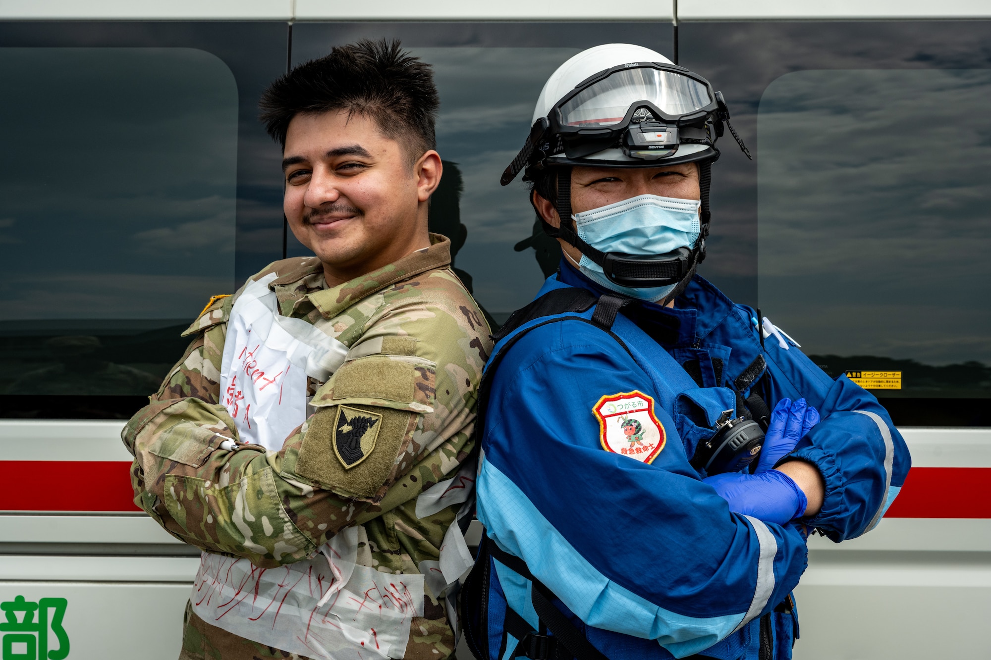 U.S. Army Spc. Vladislav Kasumov, 10th Missile Defense Battery RADAR operator, and an emergency medical technician assigned to the Tsugaru City Fire Department pose for a photo at Japan Air Self-Defense Force Shariki Sub Base, Japan, Aug. 19, 2025.