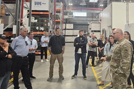 Members from the Society of American Military Engineers, or S.A.M.E., are briefed by Chief Warrant Officer 4 Zachary Cole, the Powidz Army Prepositioned Stocks-2 worksite maintenance chief with Army Field Support Battalion-Poland, (right) during their site visit to the Powidz APS-2 worksite August 21, 2025. (U.S. Army courtesy photo)