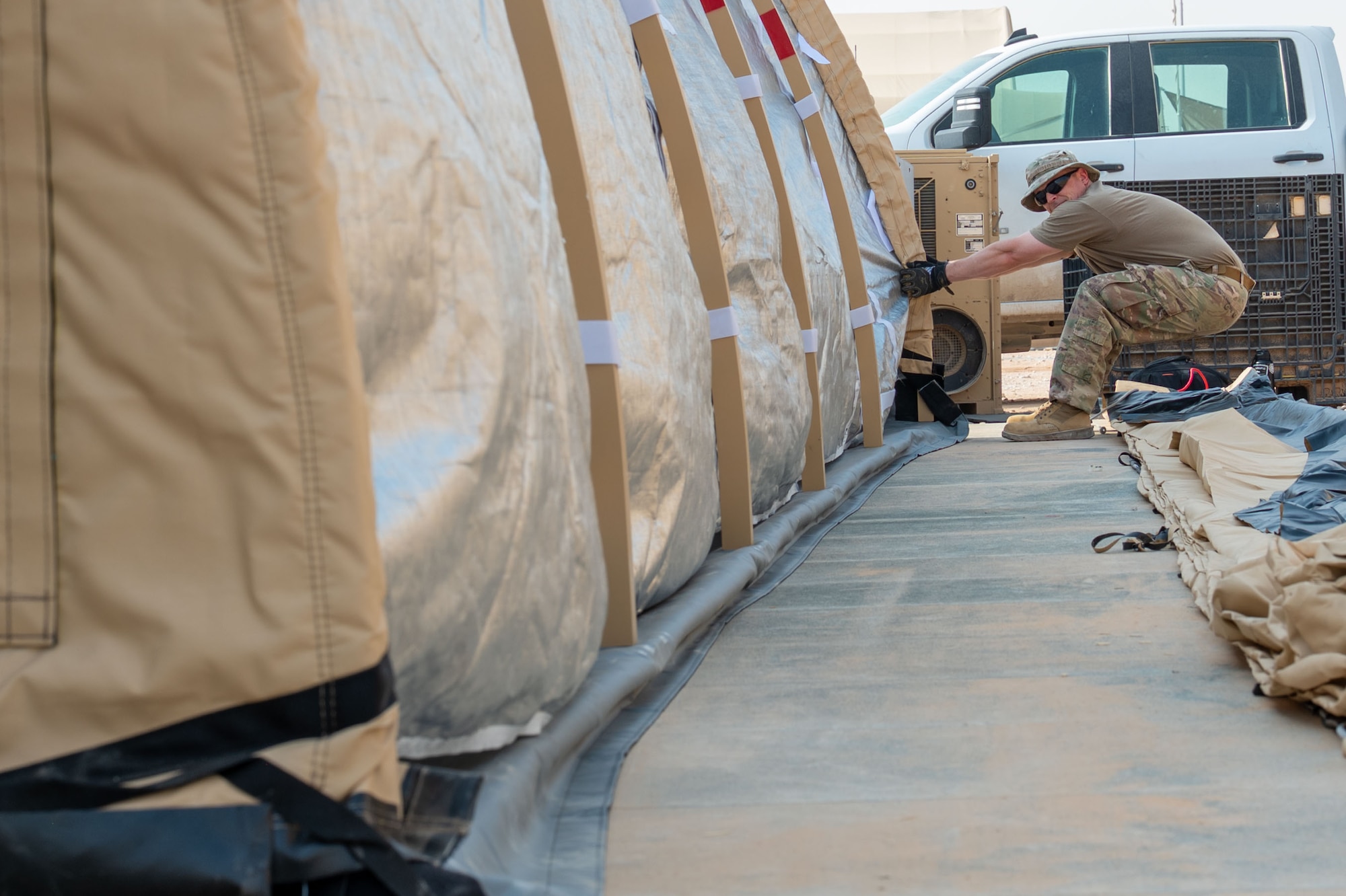 U.S. Air Force Master Sgt. Brent Morris, 378th Expeditionary Civil Engineer Squadron structures section chief, aligns a Small Shelter System.