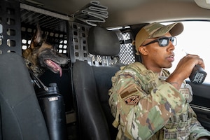 U.S. Air Force Staff Sgt. Dale Sammons Jr., 379th Expeditionary Security Forces Squadron military working dog handler, radios into dispatch during patrol within the U.S. Central Command area of responsibility, Aug. 15, 2025. With skills ranging from explosive detection to patrol and security, MWDs have enhanced military operations by supporting law enforcement efforts and security-related tasks. (U.S. Air Force photo by Senior Airman Amanda Jett)