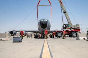 U.S. Airmen assigned to the 379th Expeditionary Maintenance Squadron and 379th Expeditionary Civil Engineer Squadron work together during a crash damaged disabled aircraft recovery exercise within the U.S. Central Command area of responsibility, Aug. 14, 2025. The CDDAR event gave members of the 379th EMXS and the 379th ECES the opportunity to execute recovery techniques and operate crash recovery equipment. (U.S. Air Force photo by Senior Airman Amanda Jett)