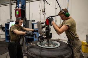 U.S. Airman 1st Class William Willis, left, and Airman 1st Class Eli Kearns, both 379th Expeditionary Maintenance Squadron wheel and tire journeymen, use a torque calibration machine to tighten bolts within the U.S. Central Command area of responsibility, Aug. 20, 2025. The 379th EMXS wheel and tire section disassembles, inspects, repairs, builds, and delivers wheels and tires to support the 379th Air Expeditionary Wing’s mission to generate combat airpower. (U.S. Air Force photo by Senior Airman Amanda Jett)