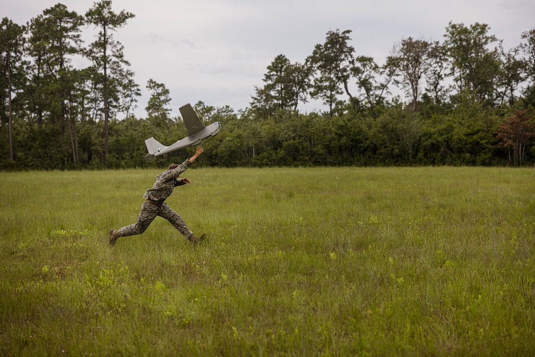 U.S. Marine Corps Cpl. Austin Morgan, a native of Virginia and a Small Unmanned Aerial System operator with 1st Battalion, 8th Marine Regiment, 2nd Marine Division, launches an RQ-20 Puma during an UAS tactical demonstration on Marine Corps Base Camp Lejeune, North Carolina, Aug. 26, 2025. Marines flew multiple UAS platforms in order to gain proficiency of the Radio Agile Integrated Device which groups UAS into a single network. (U.S. Marine Corps photo by Lance Cpl. Hunter J. Kuester)