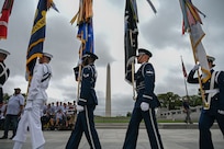 The Joint Service Color Guard presents the colors during the national anthem to honor veterans from World War II, the Vietnam War and the Korean War during a tour with Honor Flight Chicago at the WWII Memorial in Washington, D.C., Aug. 20, 2025. The event honored military veterans from WWII, the Vietnam War and the Korean War during their visit to the National Capital Region. The Air Force, Space Force and Navy members of the JSCG are assigned to Joint Base Anacostia-Bolling, Washington, D.C. (U.S. Air Force photo by Airman 1st Class Geneva Nguyen)