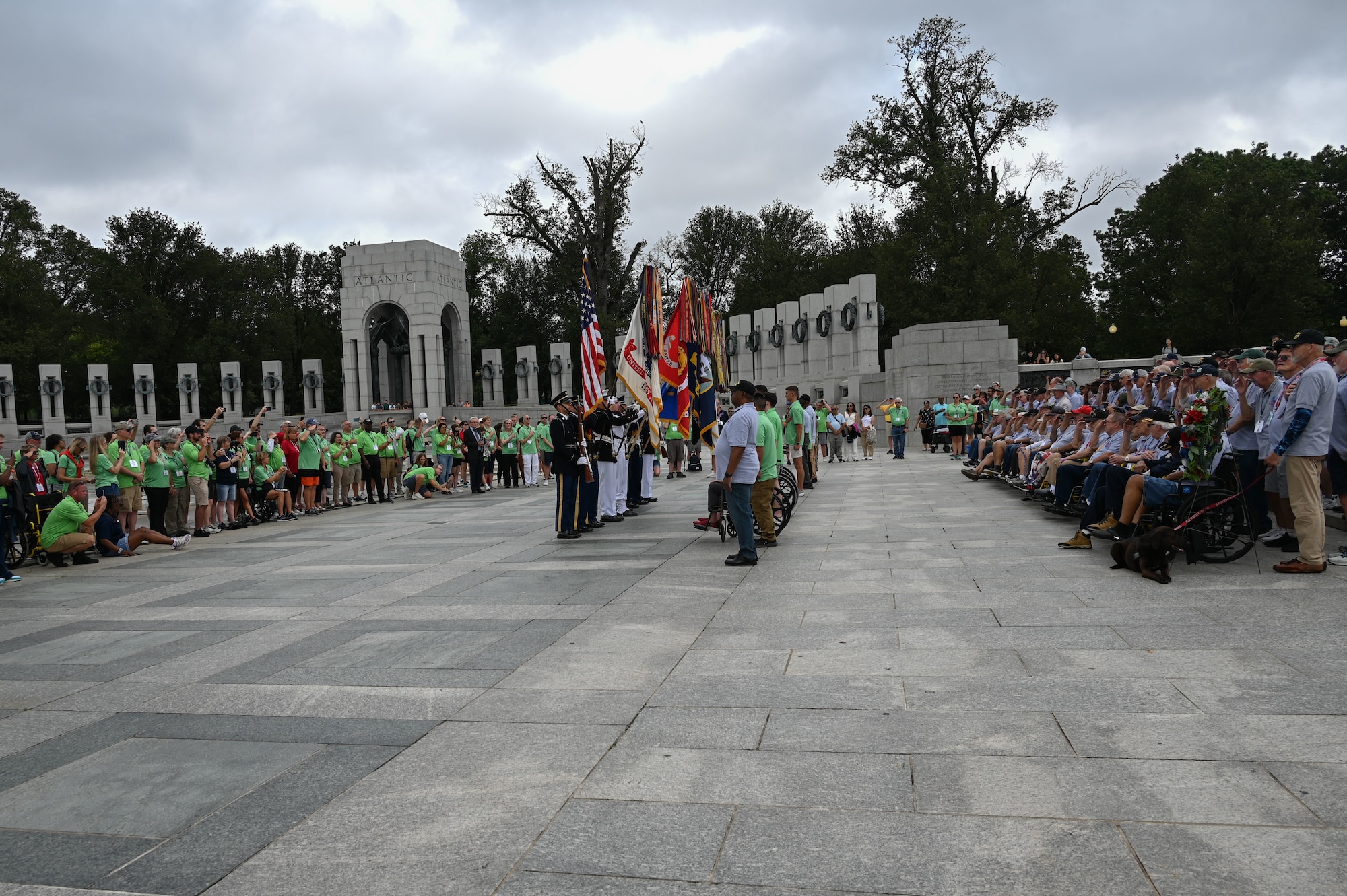 The Joint Service Color Guard presents the colors during the national anthem to honor veterans from World War II, the Vietnam War and the Korean War during a tour with Honor Flight Chicago at the WWII Memorial in Washington, D.C., Aug. 20, 2025. The event honored military veterans from WWII, the Vietnam War and the Korean War during their visit to the National Capital Region. The Air Force, Space Force and Navy members of the JSCG are assigned to Joint Base Anacostia-Bolling, Washington, D.C. (U.S. Air Force photo by Airman 1st Class Geneva Nguyen)