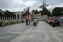 The Joint Service Color Guard presents the colors during the national anthem to honor veterans from World War II, the Vietnam War and the Korean War during a tour with Honor Flight Chicago at the WWII Memorial in Washington, D.C., Aug. 20, 2025. The event honored military veterans from WWII, the Vietnam War and the Korean War during their visit to the National Capital Region. The Air Force, Space Force and Navy members of the JSCG are assigned to Joint Base Anacostia-Bolling, Washington, D.C. (U.S. Air Force photo by Airman 1st Class Geneva Nguyen)