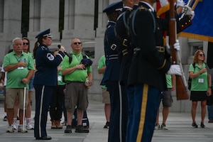 U.S. Air Force Master Sgt. Katie Edelman, soprano vocalist with The U.S. Air Force Band, performs the national anthem while the Joint Service Color Guard presents the colors for Honor Flight Chicago veterans at the World War II Memorial in Washington, D.C., Aug. 20, 2025. The event honored military veterans from WWII, the Vietnam War and the Korean War during their visit to the National Capital Region. The Air Force, Space Force and Navy members of the JSCG are assigned to Joint Base Anacostia-Bolling, Washington, D.C. (U.S. Air Force photo by Airman 1st Class Geneva Nguyen)