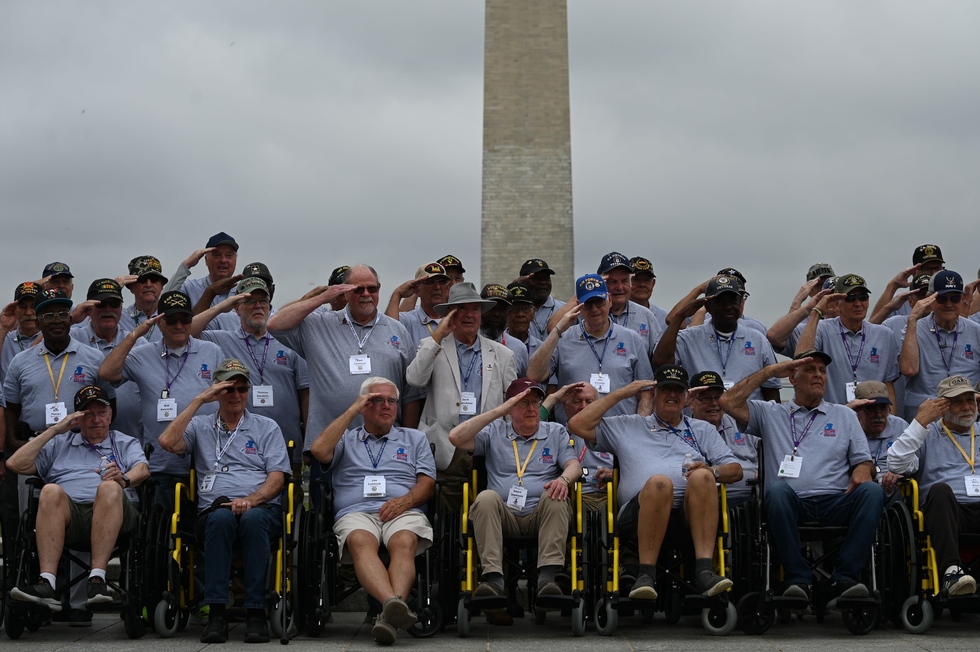 Veterans with Honor Flight Chicago salute the colors during the national anthem presented by the Joint Service Color Guard and The U.S. Air Force Band at the World War II Memorial in Washington, D.C., Aug. 20, 2025. The performance honored military veterans from WWII, the Vietnam War and the Korean War during their visit to the National Capital Region. The Air Force, Space Force and Navy members of the JSCG are assigned to Joint Base Anacostia-Bolling, Washington, D.C. (U.S. Air Force photo by Airman 1st Class Geneva Nguyen)