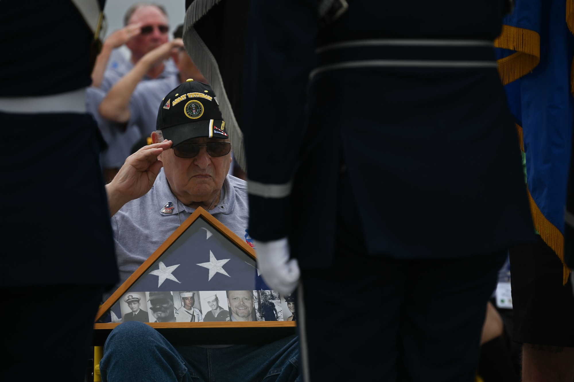 Veterans with Honor Flight Chicago salute the colors during the national anthem presented by the Joint Service Color Guard and The U.S. Air Force Band at the World War II Memorial in Washington, D.C., Aug. 20, 2025. The performance honored military veterans from WWII, the Vietnam War and the Korean War during their visit to the National Capital Region. The Air Force, Space Force and Navy members of the JSCG are assigned to Joint Base Anacostia-Bolling, Washington, D.C. (U.S. Air Force photo by Airman 1st Class Geneva Nguyen)