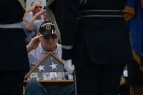 Veterans with Honor Flight Chicago salute the colors during the national anthem presented by the Joint Service Color Guard and The U.S. Air Force Band at the World War II Memorial in Washington, D.C., Aug. 20, 2025. The performance honored military veterans from WWII, the Vietnam War and the Korean War during their visit to the National Capital Region. The Air Force, Space Force and Navy members of the JSCG are assigned to Joint Base Anacostia-Bolling, Washington, D.C. (U.S. Air Force photo by Airman 1st Class Geneva Nguyen)