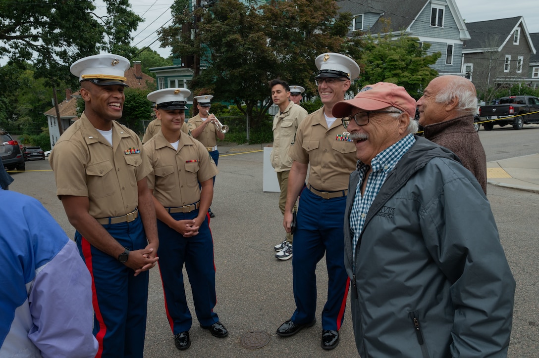 U.S. Marines with the Special Purpose Marine Air-Ground Task Force-250 speak with Louis Cappuccio and Angelo Cappuccio, sons of U.S. Marine Corps Cpl. Joseph J. Cappuccio, who served in the Battle of Iwo Jima, at a WWII dedication during Marine Week Boston 2025, Aug. 21, 2025. Joseph J. Cappuccio Square was renamed in honor of Cpl. Cappuccio’s service. (U.S. Marine Corps photo by Lance Cpl. Matthew A. McDonnell)