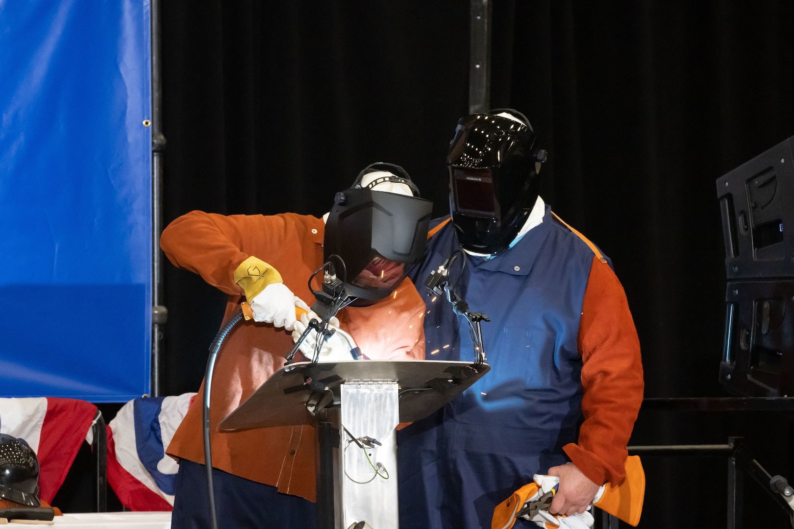 Dr. Kelly Geurts, ship sponsor of the future Columbia-class ballistic missile submarine USS Wisconsin (SSBN 827), welds her initials into the ship’s keel during its keel-laying ceremony under the supervision of General Dynamics Electric Boat welder Robert Ray Jr.