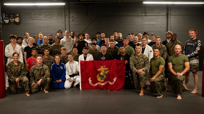 U.S. Marines assigned to Special Purpose Marine Air-Ground Task Force-250 pose for a group photo with members of Broadway Jiu-Jitsu after a martial arts collaboration at Broadway Jiu-Jitsu during Marine Week Boston, Aug. 22, 2025. Marines stationed across the globe commemorate the 250th anniversary of the Marine Corps, honoring a distinguished legacy of service, sacrifice, and unwavering fidelity to both the nation and fellow Marines. (U.S. Marine Corps photo by Cpl. Vincent Needham)